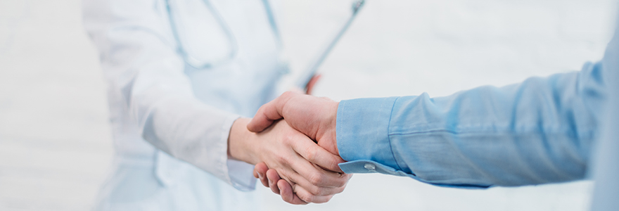 Cropped shot of doctor shakign-hands of parents