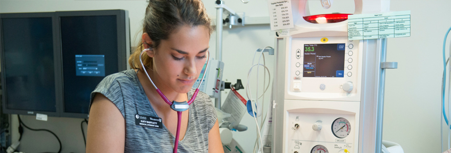 Medical student standing near the incubator