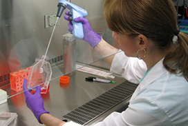 A woman in a white lab coat in a lab