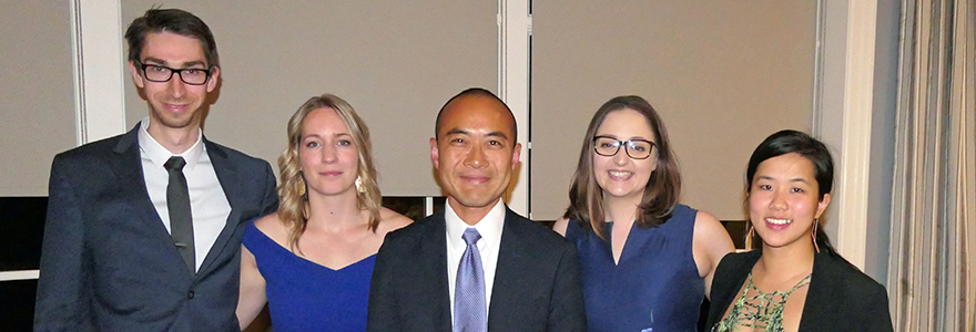 Photograph of four residents and Dr. Kevin Fung at Resident Research Day.