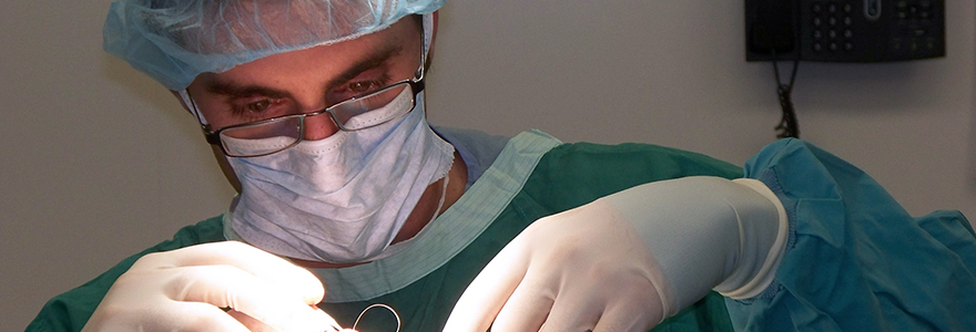A physician wearing a green mask.