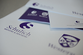Photograph of a number of Schulich Medicine & Dentistry publication showing the logo.