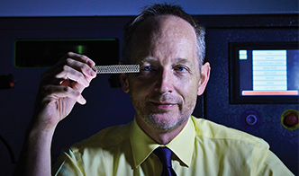 David Holdsworth, PhD, examines a stainless steel mesh tube manufactured with the only 3D metal printer in Canada