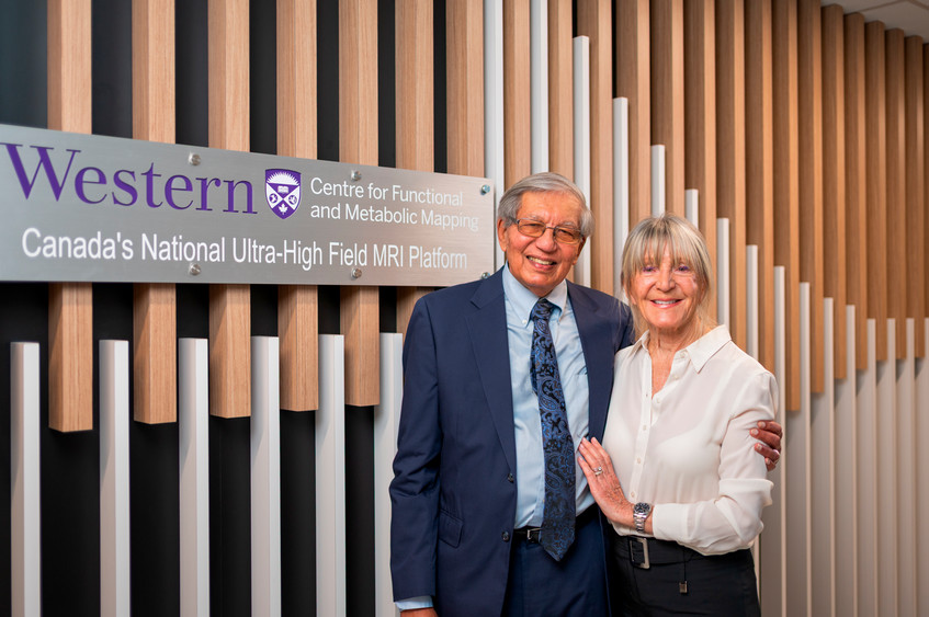 Frank and Janice Lochan standing beside the Western Centre for Functional and Metabolic Mapping sign