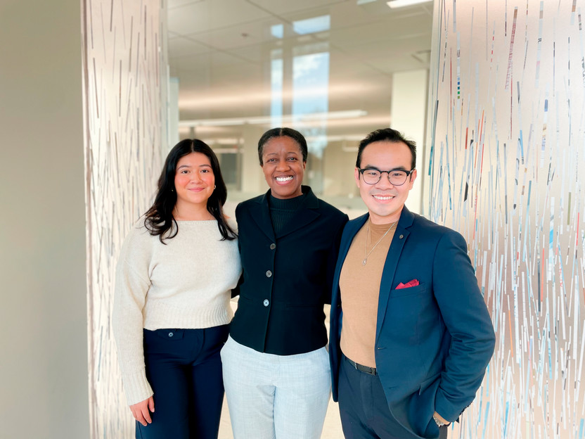 Three members of Western's Master of Public Health program smiling together in a hallway