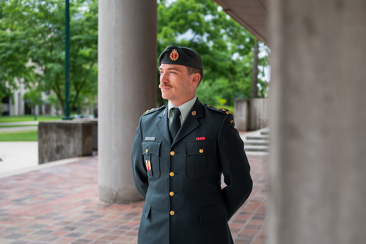 Michael Hutchinson in Canadian Armed Forces dress uniform, standing outdoors on Western's campus