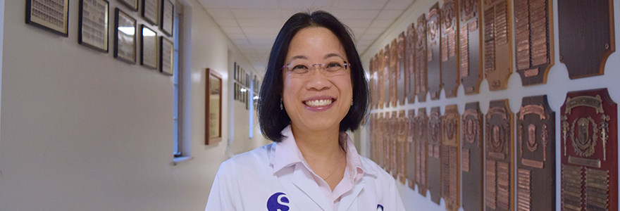 Photograph of Dr. Cecilia Dong standing in a hallway