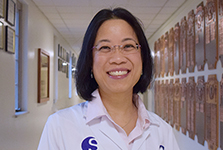 Photograph of Dr. Cecilia Dong standing in the hallway
