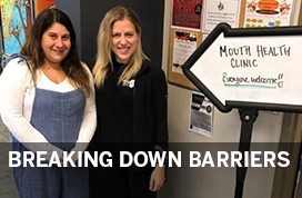 Photograph of Dr. Hannah Ernst at the Mouth Health Clinic sign