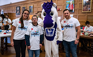 Photograph of two dentistry students with the university mascot